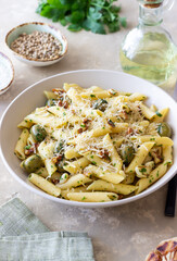 Pasta penne with olives, nuts, herbs and cheese. Healthy food. Italian cuisine. Vegetarian food.