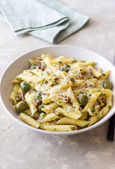 Pasta penne with olives, nuts, herbs and cheese. Healthy food. Italian cuisine. Vegetarian food.