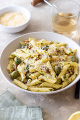 Pasta penne with olives, nuts, herbs and cheese. Healthy food. Italian cuisine. Vegetarian food.