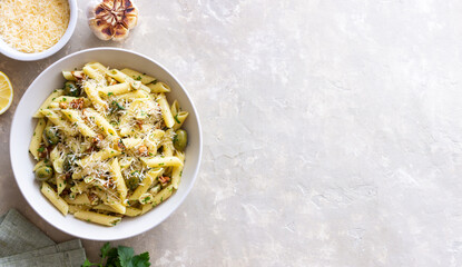 Pasta penne with olives, nuts, herbs and cheese. Healthy food. Italian cuisine. Vegetarian food.