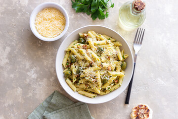 Pasta penne with olives, nuts, herbs and cheese. Healthy food. Italian cuisine. Vegetarian food.