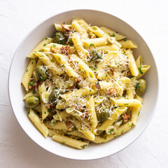 Pasta penne with olives, nuts, herbs and cheese. Healthy food. Italian cuisine. Vegetarian food.