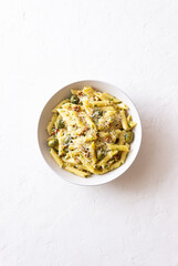 Pasta penne with olives, nuts, herbs and cheese. Healthy food. Italian cuisine. Vegetarian food.