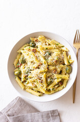 Pasta penne with olives, nuts, herbs and cheese. Healthy food. Italian cuisine. Vegetarian food.