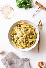 Pasta penne with olives, nuts, herbs and cheese. Healthy food. Italian cuisine. Vegetarian food.