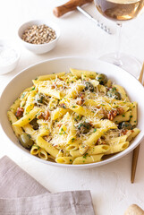 Pasta penne with olives, nuts, herbs and cheese. Healthy food. Italian cuisine. Vegetarian food.