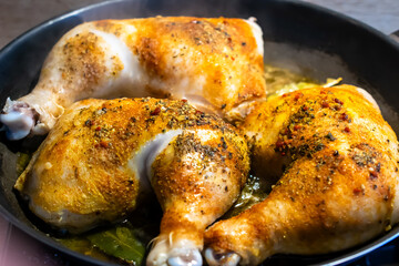chicken legs roasting in a pan