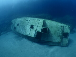 a boat wreck underwater metal on ocean floor 