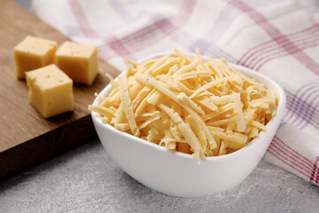 Heap of grated delicious cheese. Concept: Italian cuisine, cheese, restaurant, and food.