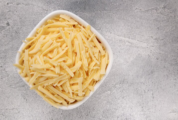 Heap of grated delicious cheese. Concept: Italian cuisine, cheese, restaurant, and food.