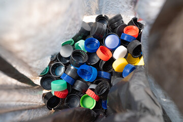 
recycling plastic caps inside a black bag