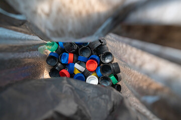 
plastic bottle caps inside a black bag