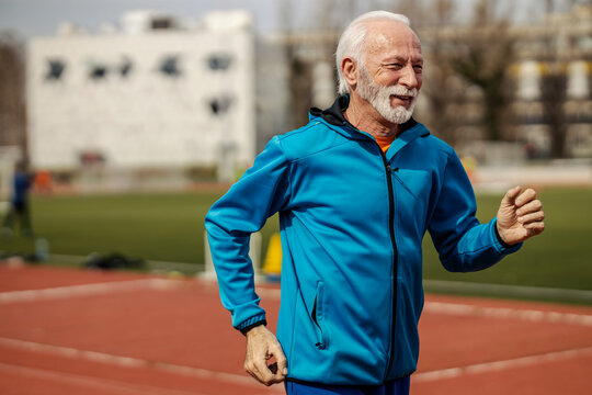Senior runner running on stadium.