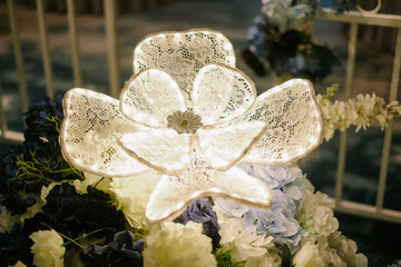 Elegant lace flower decoration with soft illumination and floral accents
