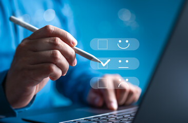 A person select the happy face option on a digital survey form displayed on laptop. The form...