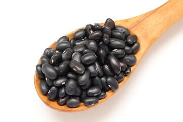 black beans in spoon on white background