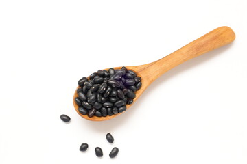 Top view of black beans in spoon on white background 