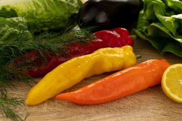 Red and yellow peppers close-up. Fresh vegetables for salad on the table