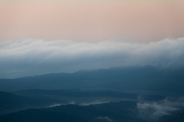 hazy view of forests at dusk on the hills in mpumalanga
