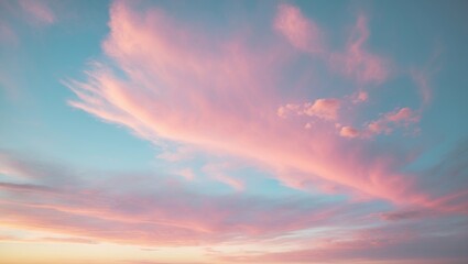 Obraz premium Sunset sky at dawn featuring sunrise and gentle pink clouds mixed with yellow hues.