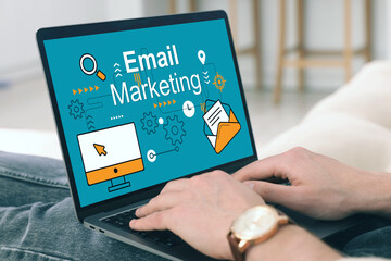 Email marketing. Man using laptop at home, closeup