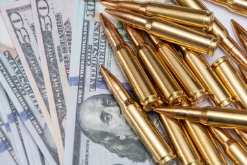 Arms financing - cartridges on money as a symbol of economic policy.