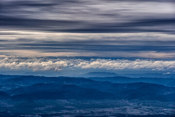 Cloudscape With Cumulus Clouds Above Mountains