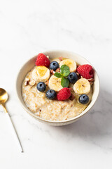 Oatmeal Bowl, Oat Porridge with berries, Banana and nuts in a Bowl, Healthy Snack or Breakfast