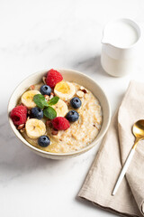 Oatmeal Bowl, Oat Porridge with berries, Banana and nuts in a Bowl, Healthy Snack or Breakfast