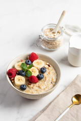 Oatmeal Bowl, Oat Porridge with berries, Banana and nuts in a Bowl, Healthy Snack or Breakfast
