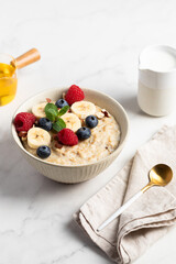 Oatmeal Bowl, Oat Porridge with berries, Banana and nuts in a Bowl, Healthy Snack or Breakfast