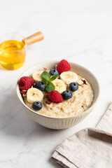 Oatmeal Bowl, Oat Porridge with berries, Banana and nuts in a Bowl, Healthy Snack or Breakfast