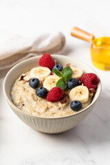 Oatmeal Bowl, Oat Porridge with berries, Banana and nuts in a Bowl, Healthy Snack or Breakfast