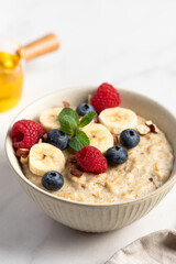 Oatmeal Bowl, Oat Porridge with berries, Banana and nuts in a Bowl, Healthy Snack or Breakfast