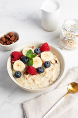 Oatmeal Bowl, Oat Porridge with berries, Banana and nuts in a Bowl, Healthy Snack or Breakfast
