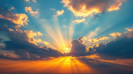 Sunset sky with sunbeams streaming through layers of clouds