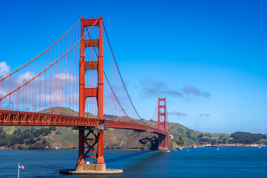 Golden Gate Bridge over blue waters with scenic hills in San Francisco