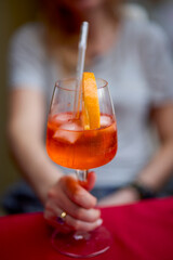 Happy woman celebrating with a glass of Aperol