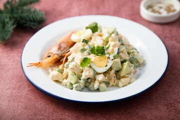 Russian salad with shrimps and avocado