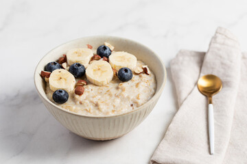 Oatmeal Bowl, Oat Porridge with berries, Banana and nuts in a Bowl, Healthy Snack or Breakfast