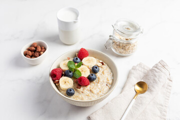 Oatmeal Bowl, Oat Porridge with berries, Banana and nuts in a Bowl, Healthy Snack or Breakfast