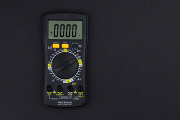 Digital multimeter on dark background