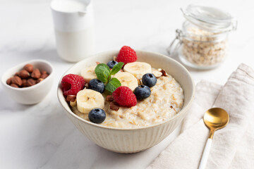 Oatmeal Bowl, Oat Porridge with berries, Banana and nuts in a Bowl, Healthy Snack or Breakfast