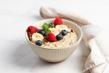 Oatmeal Bowl, Oat Porridge with berries, Banana and nuts in a Bowl, Healthy Snack or Breakfast