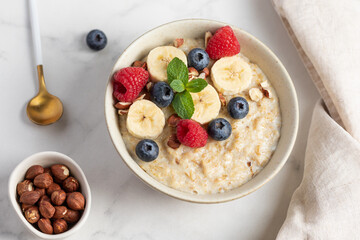 Oatmeal Bowl, Oat Porridge with berries, Banana and nuts in a Bowl, Healthy Snack or Breakfast