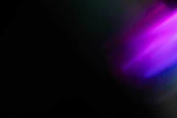 Abstract blurred colorful lens flare bokeh on black,