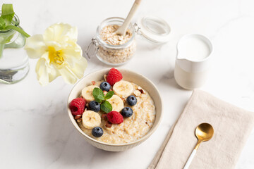 Oatmeal Bowl, Oat Porridge with berries, Banana and nuts in a Bowl, Healthy Snack or Breakfast