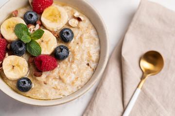 Oatmeal Bowl, Oat Porridge with berries, Banana and nuts in a Bowl, Healthy Snack or Breakfast
