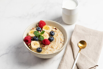 Oatmeal Bowl, Oat Porridge with berries, Banana and nuts in a Bowl, Healthy Snack or Breakfast