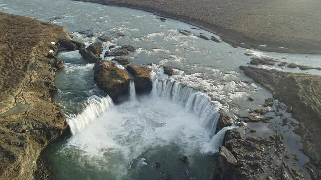 aerial footage of golden hour godafoss waterfall in iceland